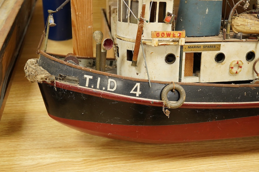 A scale model of a tug boat ‘T.I.D 4’, a well detailed model with the remains of internal wiring and electric motor for use as a pond yacht, length of hull approx 92cm. Condition - poor to fair, now in need of some resto